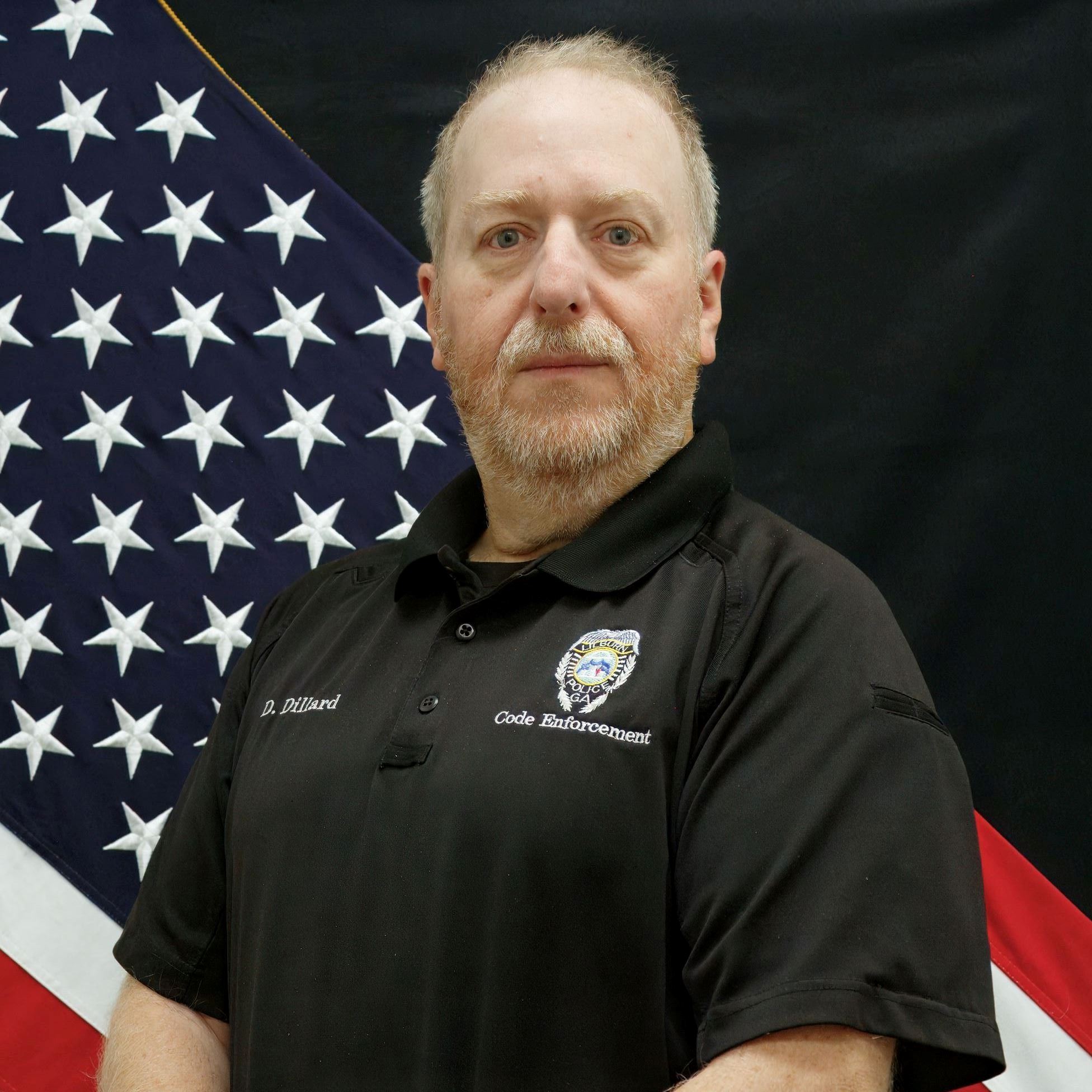 Headshot of William Dillard male with light colored hair/beard wearing black polo