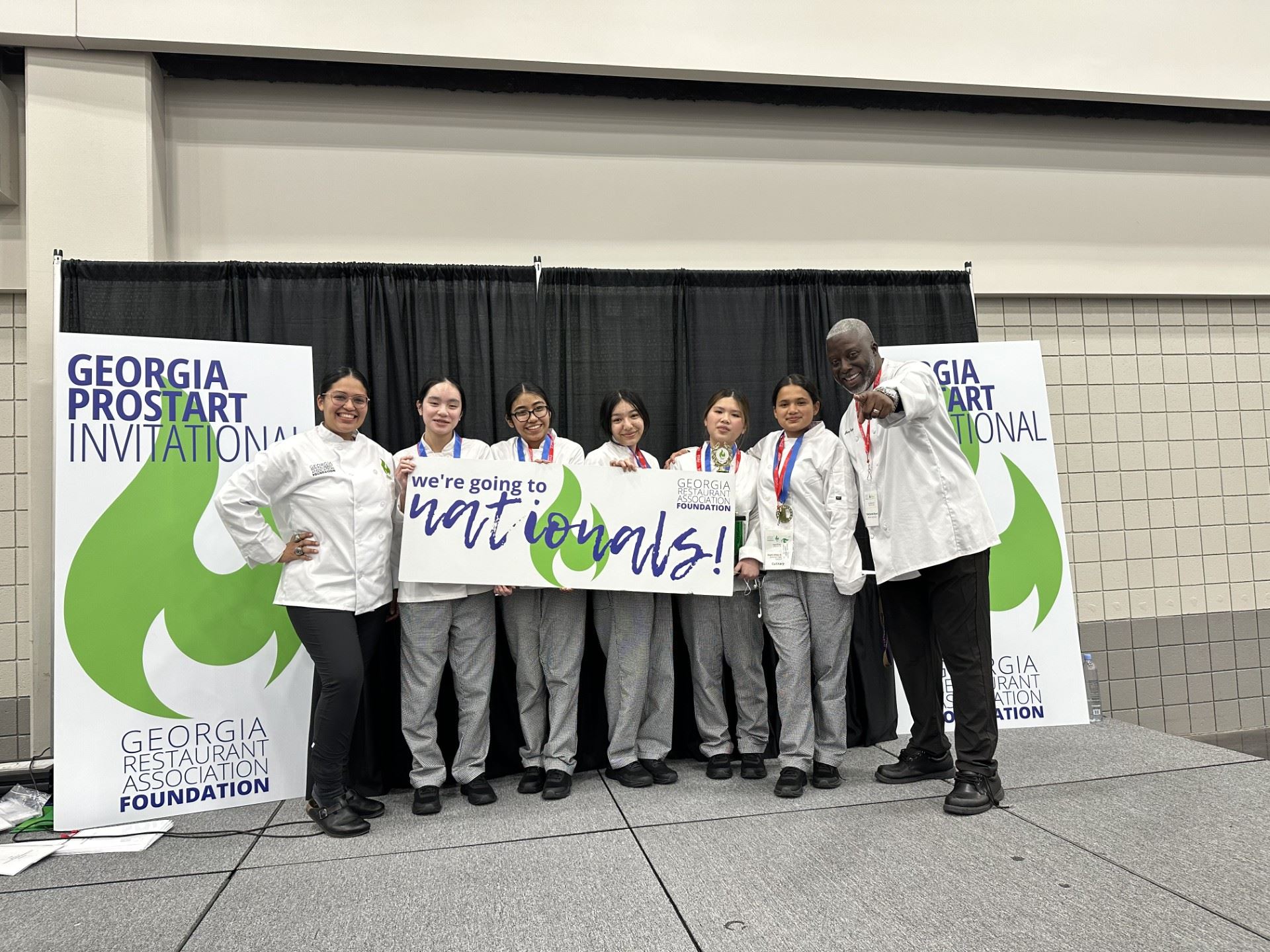 students and teacher pose with \